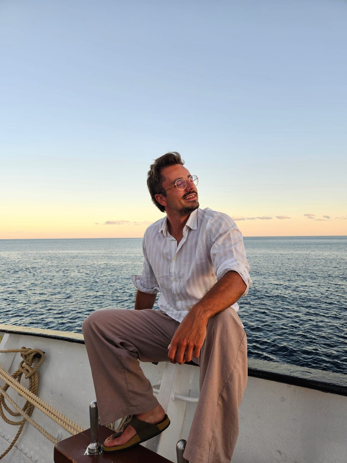 Tolek on board a tall ship at sunset